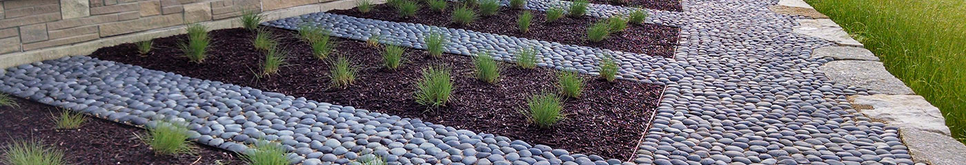 Landscaped garden with decorative stone and planting, from Kon Kast’s landscape-products page